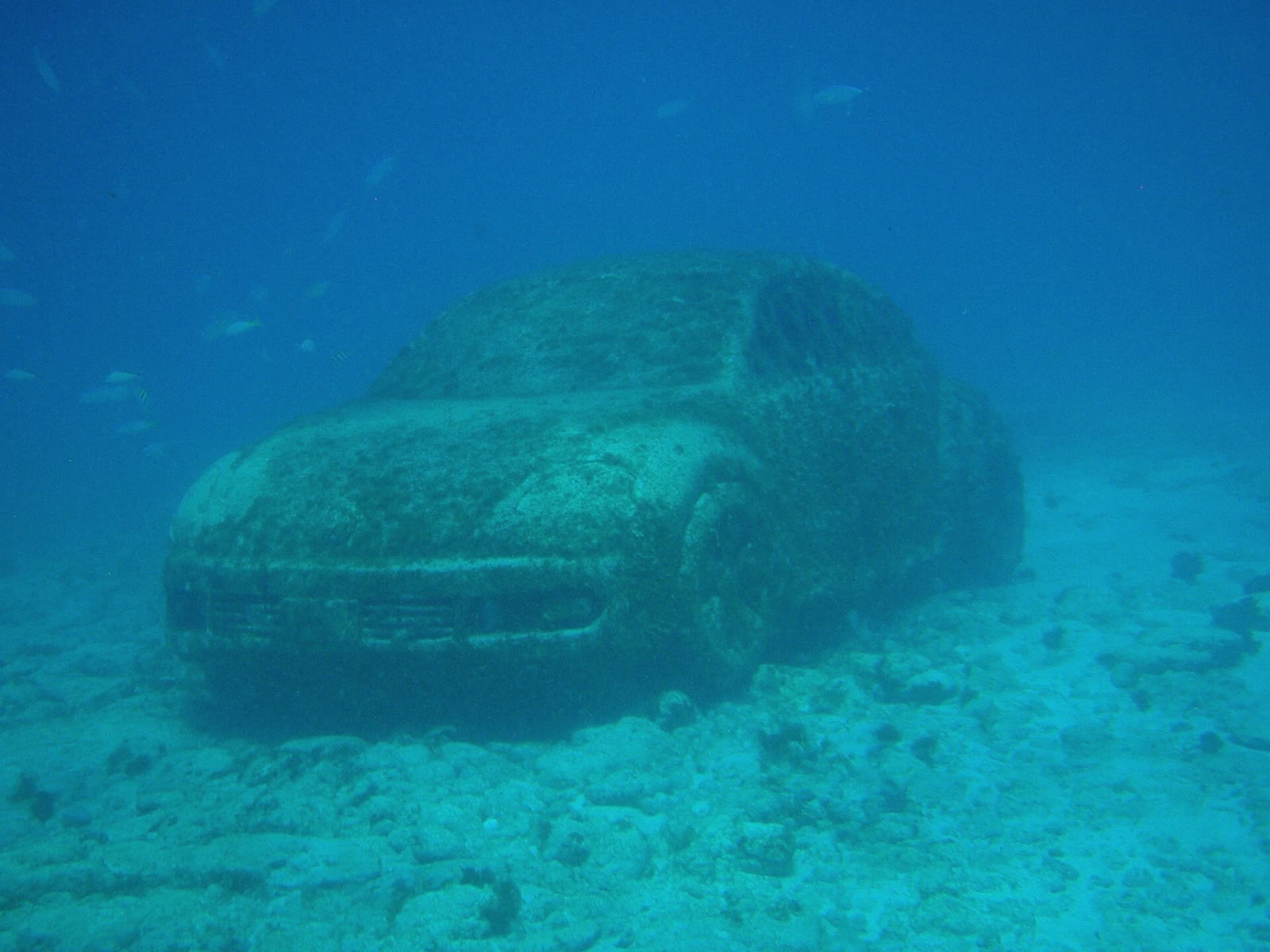 Underwater Volkswagen beetle sculpture colonised by marine life at MUSA near Cancun, Mexico